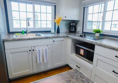 Modern kitchen in Iron Horse Living rental unit with appliances, cabinets, and sink.