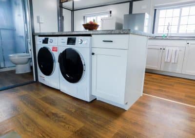 Iron Horse Living rental home in Odessa featuring in-unit washer and dryer next to kitchen area.