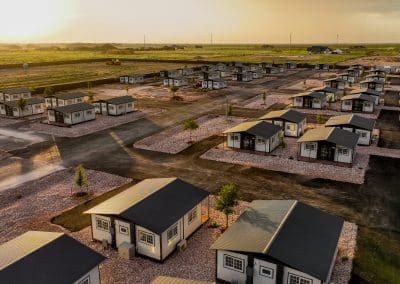 Sunset aerial of Iron Horse Living community in Odessa, featuring gated entry, paved roads, fiber internet, and landscaped lots.